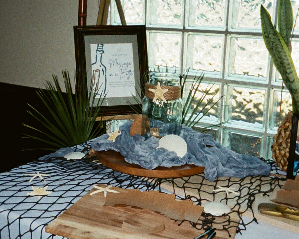 Nautical Memorial Guest Book Display Message in a bottle memorial guestbook display with seashells and fishing net for nautical celebration of life, Orange County