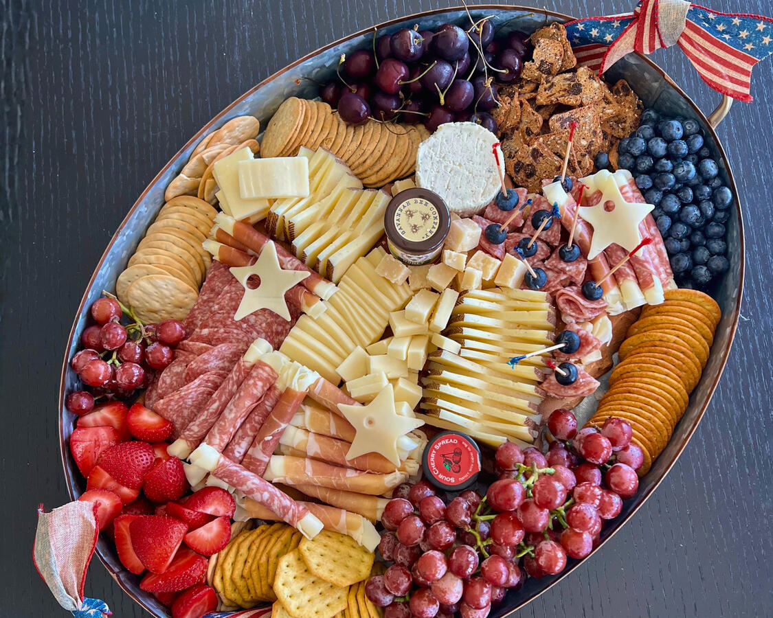Patriotic Baby Shower Charcuterie Board Design Red white and blue charcuterie board with star-shaped cheese and berries for Fourth of July baby shower, Orange County