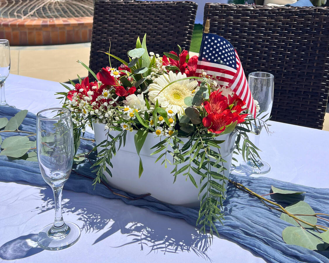 Baby Shower Floral Centerpiece — Red White and Due Red and white floral centerpiece with American flag accent for outdoor patriotic baby shower table design