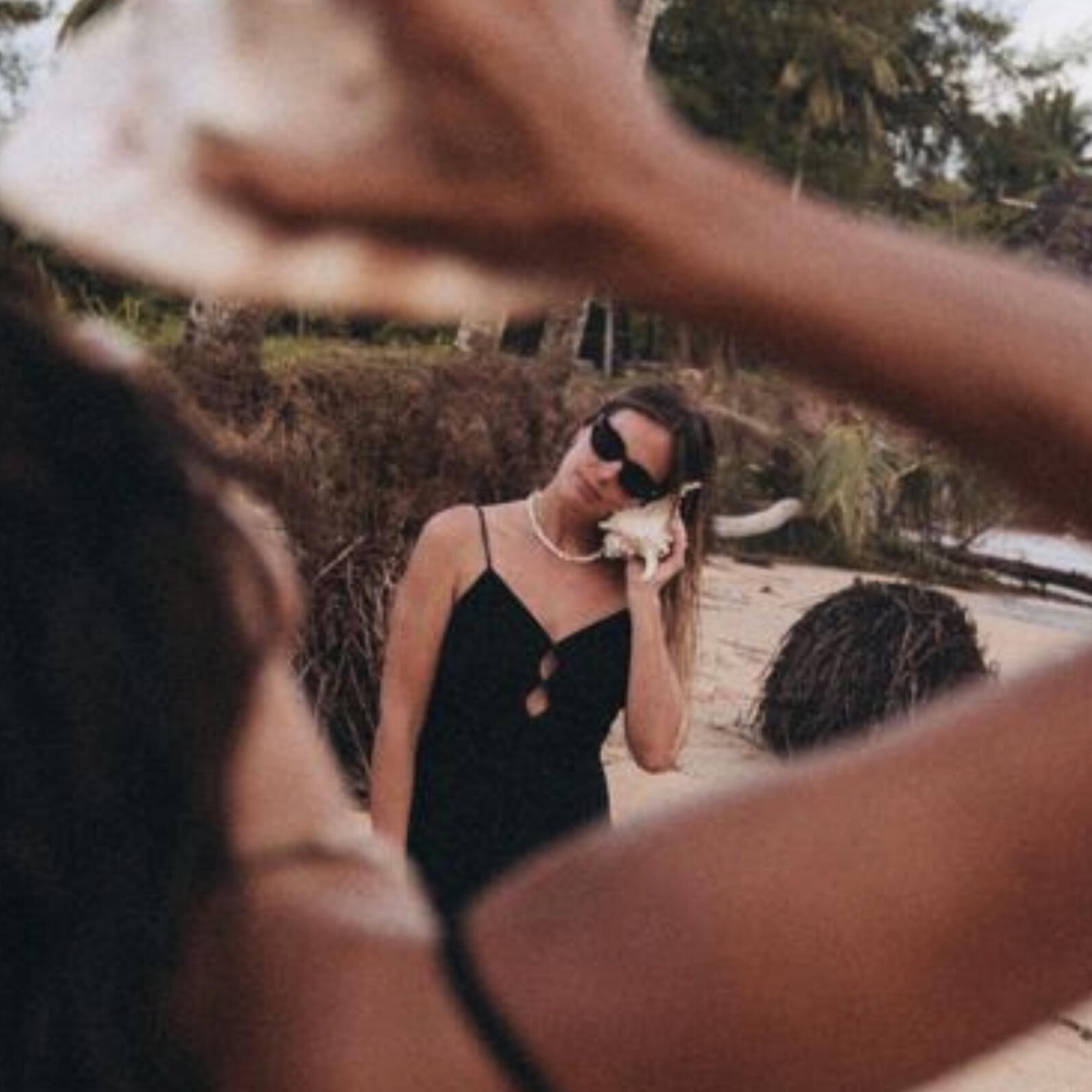 Woman Holding a Telephone Women holding a beachy shell phone to her ear